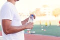 Thirsty man open a bottle of pure water at sport stadium
