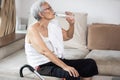 Thirsty senior woman suffering from heat,drinking fresh water from a bottle to quench their thirst in hot summer weather,high Royalty Free Stock Photo