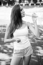 Thirsty woman drink water from bottle on stadium. Drinking water after training and workout. Thirst and dehydration Royalty Free Stock Photo