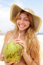 Thirsty woman drinking coconut water on the beach Royalty Free Stock Photo