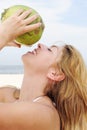 Thirsty woman drinking coconut water, close-up