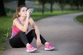 Thirsty woman drinking water to recuperate after jogging Royalty Free Stock Photo