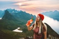 Thirsty woman hiker drinking water with plastic bottle on mountain top Travel lifestyle adventure active vacations
