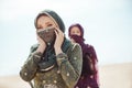 Thirsty women walking in a desert. Lost during the travel Royalty Free Stock Photo