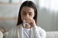 Thirsty young woman drink clean mineral water