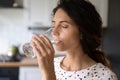 Thirsty young woman drink water from glass