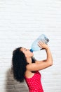 Thirsty Young Woman Drinking Water From Plastic Bottle For Health