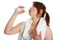 Thirsty young women drinking water after fitness