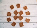 thirteen pieces of bread lie on white boards