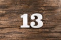 Thirteen 13 - White wooden number on rustic background