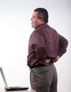 Thirties hispanic businessman backpain Royalty Free Stock Photo