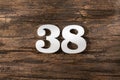 Thirty eight 38 - White wooden number on rustic background