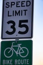 Thirty five an hour speed limit sign, and a bike route sign Royalty Free Stock Photo