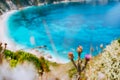 Thistle plant flower on blurred background with azure blue sea water petani beach. Summer on Kefalonia island, Greece Royalty Free Stock Photo