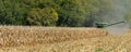 Panorama landscape of a John Deer combine harvesting a corn field