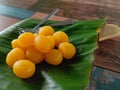 Thong Yod or Round Egg Yolk Tart, an ancient Thai dessert, orange and gold, has a sweet taste on banana leaf