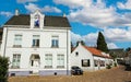 Cobblestone street with traditional white ancient dutch country houses in rural village