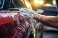 Thorough Man washing car headlight with rag closeup. Generate Ai