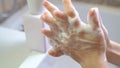Thorough washing of kid hands soap foam and water