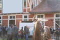 Thoroughbred horse is being washed after racing competition near crowd of people Royalty Free Stock Photo