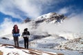 Thorung or Thorong peak with two tourists Royalty Free Stock Photo