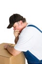Thoughful worker leaning against cardboard box