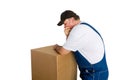 Thoughful worker standing over cardboard box