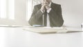 Thoughtful accountant sitting at his desk with paperwork