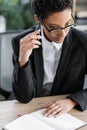 thoughtful african american businesswoman holding pen Royalty Free Stock Photo