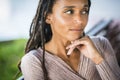 Thoughtful african american woman with hand on chin. Black woman with deadlocks hairstyle. Dreamy young black woman looking away, Royalty Free Stock Photo