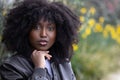 Contemplative African American Woman with Natural Afro in Leather Jacket