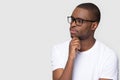 Thoughtful african man holding hand on chin looking at copyspace Royalty Free Stock Photo