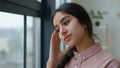 Thoughtful Arabian Indian woman student pensive dreamy female businesswoman girl looking at window in home office Royalty Free Stock Photo