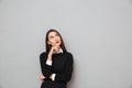 Thoughtful asian business woman in business clothes holding her chin