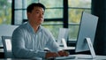 Thoughtful asian korean chinese ceo businessman dreamer smart japanese man guy sit at office desk planning business plan Royalty Free Stock Photo