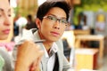 Thoughtful asian man in glasses at office