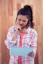 Thoughtful Asian woman using tablet Royalty Free Stock Photo