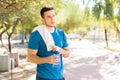 Thoughtful Male Holding Water Bottle After Exercise In Park Royalty Free Stock Photo