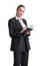 Thoughtful attractive business woman in formal suit is holding a planner, notebook and taking notes. Businesswoman  over Royalty Free Stock Photo