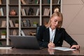 Thoughtful attractive businesswoman wearing formal wear sitting singing contract