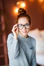 Thoughtful attractive redhead woman bending forwards and looking up to the side with a contemplative expression against Royalty Free Stock Photo