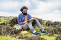 Thoughtful beard author seriously writing novel while sitting on top of hill - conept of artist, creativity and