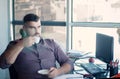 Thoughtful bearded businessman having break, drinking coffee at Royalty Free Stock Photo