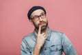 Thoughtful bearded male being deep in thoughts, looks with pensive expression into camera, concentrated on something, poses again Royalty Free Stock Photo