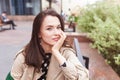 Thoughtful beautiful girl looking at the camera. Beautiful young woman on the street of the city. Copy space Royalty Free Stock Photo