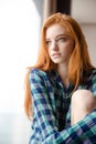 Thoughtful beautiful redhead lady looking away