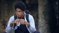 Thoughtful black student holding snack outdoors, teen feeling lonely, puberty