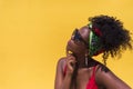 Side view of an afro woman with sunglasses looking aside thoughtfully Royalty Free Stock Photo