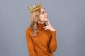 thoughtful blonde woman in crown. arrogance and selfishness. portrait of glory. Royalty Free Stock Photo