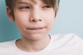 Thoughtful boy with bitter prank bitten his lower lip with his teeth and narrowed his eyes Royalty Free Stock Photo